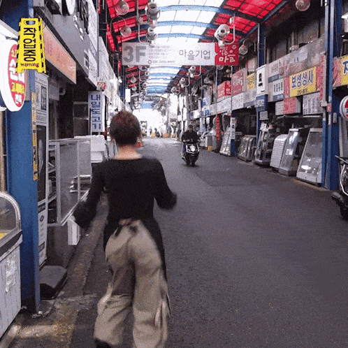 a woman walks down a street with a sign that says 3f on it