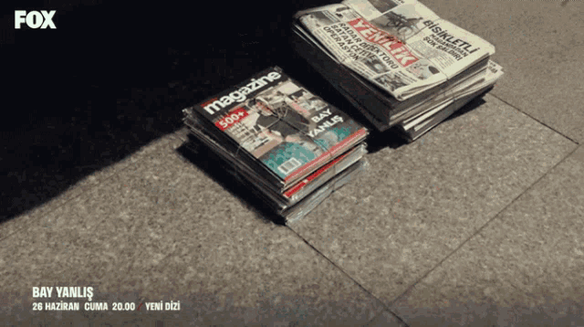a stack of magazines and a stack of newspapers with the fox logo
