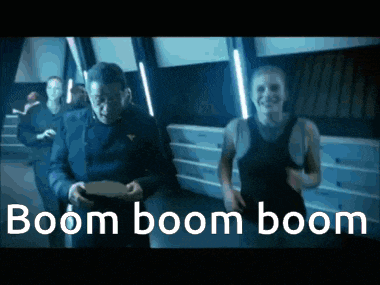 a man and a woman are dancing in a room with the words boom boom boom written in white letters .