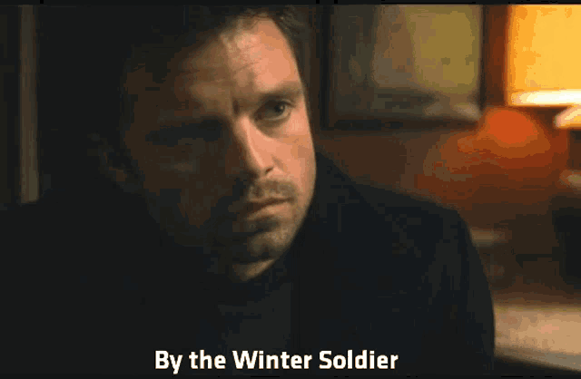 a close up of a man 's face with the words by the winter soldier on the bottom