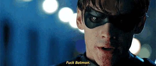 a close up of a man wearing a mask and saying fuck batman