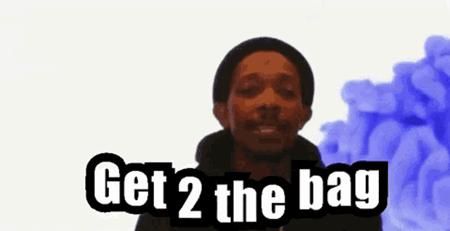 a man in a black hat says " get 2 the bag " in front of a blue background
