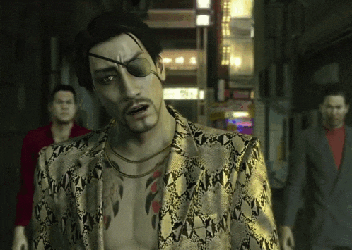 a man with a tattoo on his chest is wearing a gold jacket with a snake print