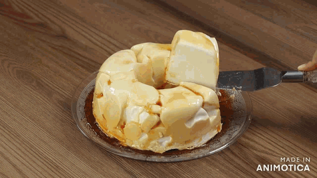 a cake with a slice taken out of it is on a plate that says made in animatica