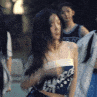 a woman wearing a crop top with the word ui on it