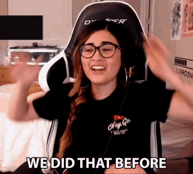 a woman wearing glasses and headphones is sitting in a gaming chair and saying we did that before .