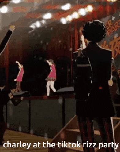 a man in a suit is standing on a stage watching a group of people dancing .
