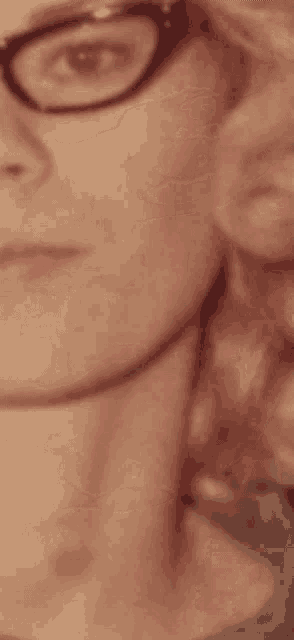 a close up of a woman 's face with glasses