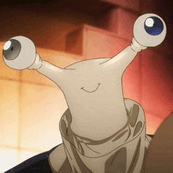 a close up of a cartoon character with two eyes and a smile on its face .