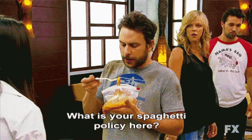 a man is holding a bag of spaghetti and asking what is your spaghetti policy here .