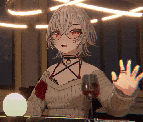 a girl sitting at a table with a glass of wine in front of her