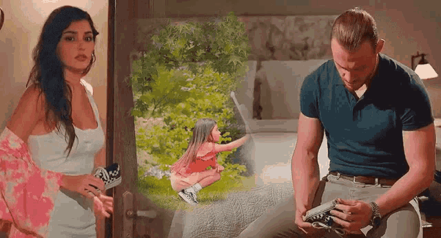 a man and a woman are standing next to each other in a bedroom while a little girl is sitting on a bed .