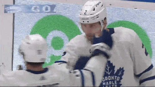 two toronto maple leafs players are hugging