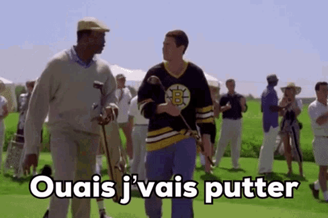 a man in a boston bruins jersey is holding a golf club and talking to another man .