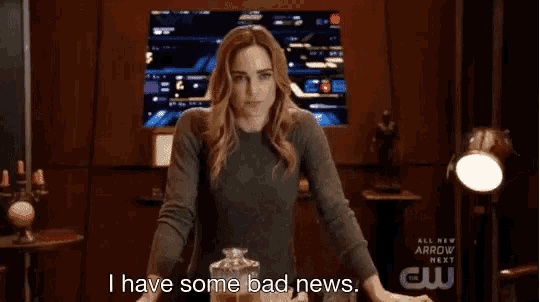 a woman is sitting at a table and talking about bad news .