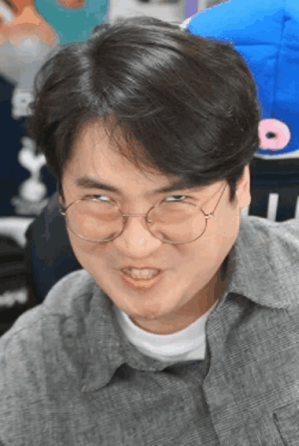 a man wearing glasses is making a funny face with his mouth open