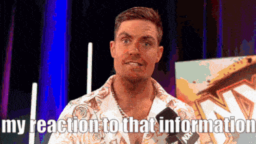 a man is talking into a microphone with the words my reaction to that information below him