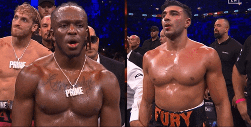 a man with the word fury on his shorts is standing next to another man