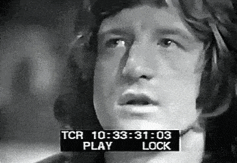 a black and white photo of a man 's face with a tcr play and lock displayed on the screen .
