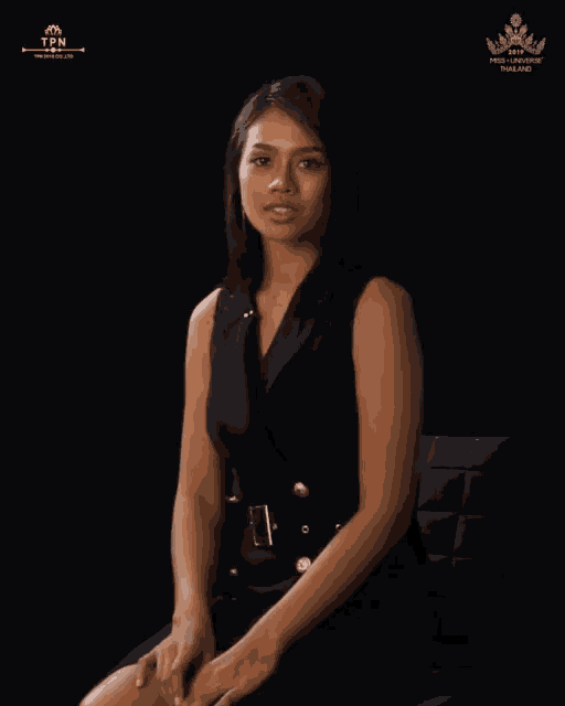 a woman in a black dress sits in front of a black background that says miss universe thailand