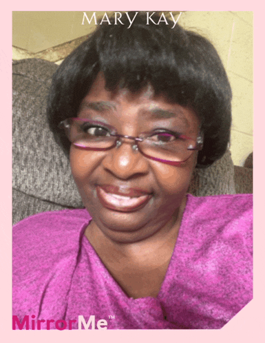 a woman wearing glasses and a pink shirt with mary kay on the top