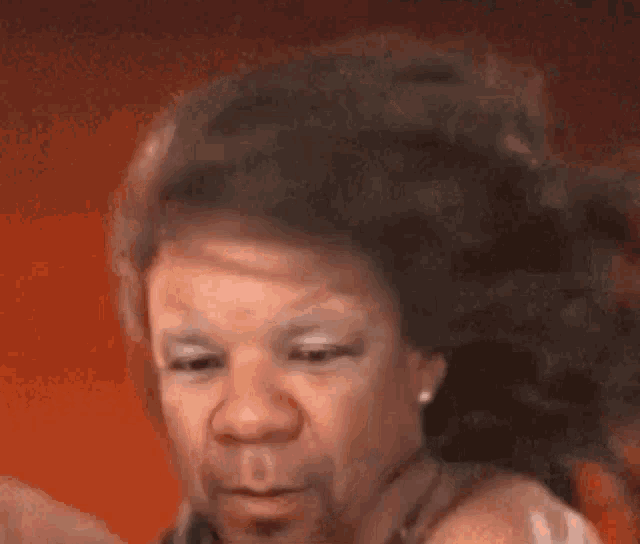 a close up of a woman 's face with a funny face .
