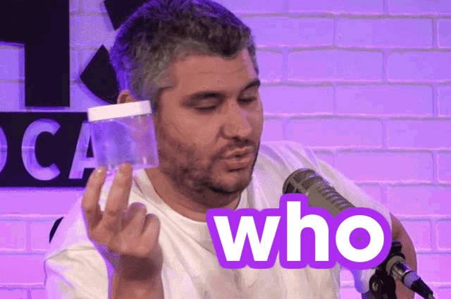 a man in a white shirt holds a jar and says who