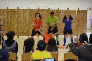 a group of people are dancing in front of a crowd of people