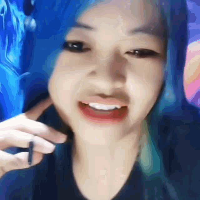 a woman with blue hair is making a funny face .