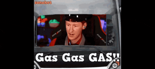 a man sitting in a car with the words gas gas gas on the bottom