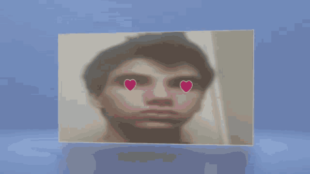 a picture of a young man with hearts on his eyes