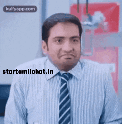 a man in a striped shirt and tie making a funny face