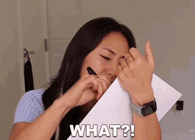 a woman is holding a piece of paper and asking what