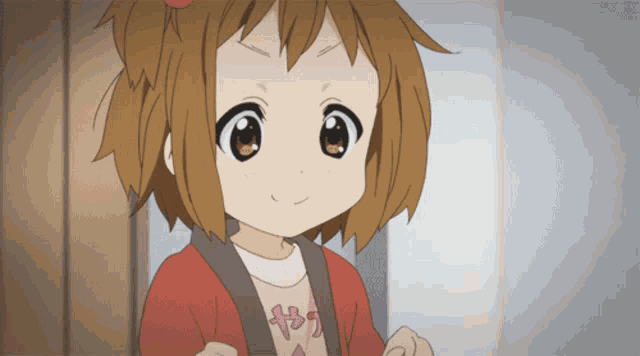 a little girl with brown hair is wearing a pink shirt that says ' y2 ' on it
