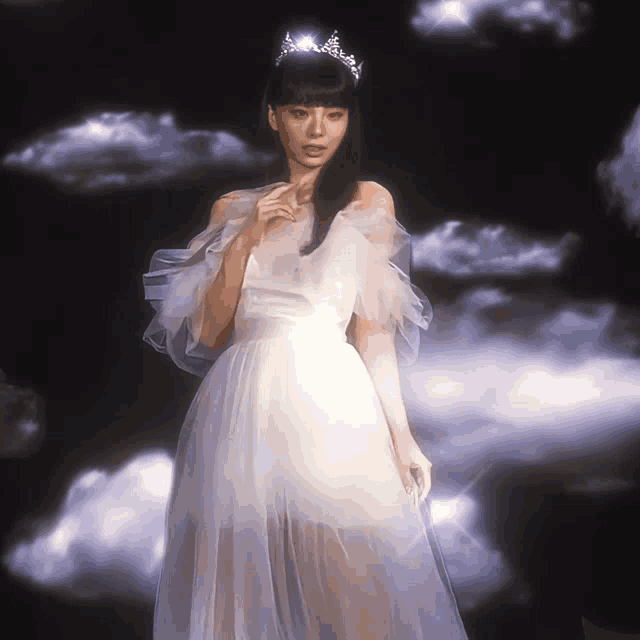 a woman wearing a tiara and a white dress