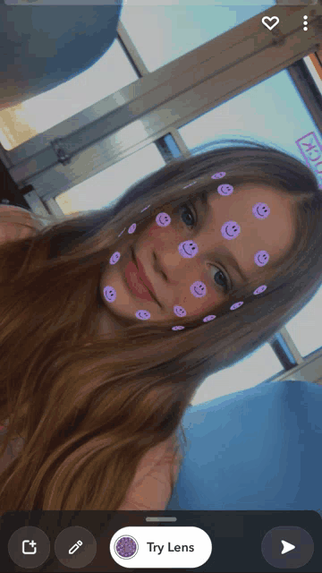 a girl with purple smiley faces on her face and the words try lens on the bottom
