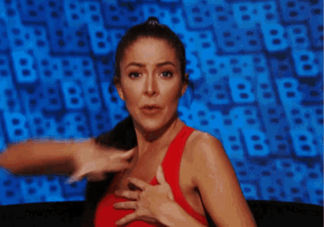 a woman in a red tank top is making a funny face