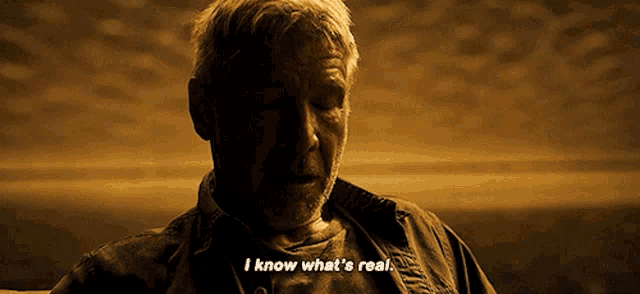 a man with a beard is sitting down and saying i know what 's real .