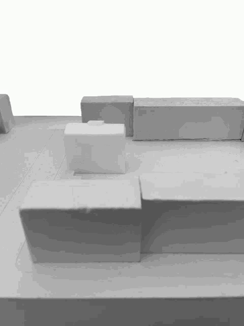 a black and white model of a building with a white block in the middle