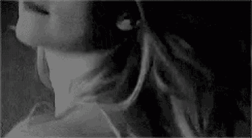 a black and white photo of a woman 's neck and ear .