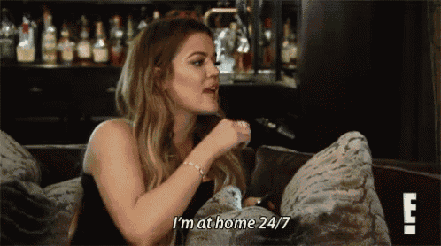 a woman is sitting on a couch talking to someone and says `` i 'm at home 24/7 ''