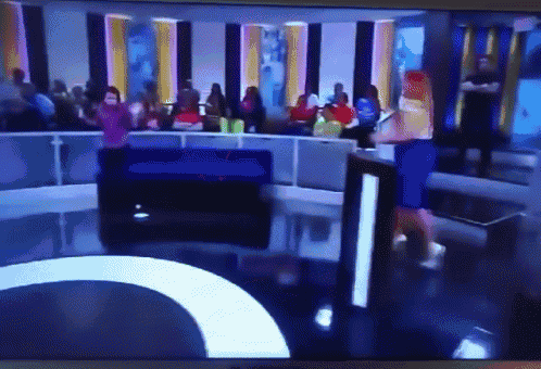 a group of people are watching a show on a television screen