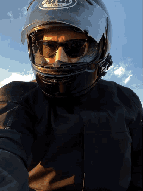 a man wearing a helmet that says arai helmet on it