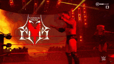 a man in a wrestling ring with the word karrion kross on the screen