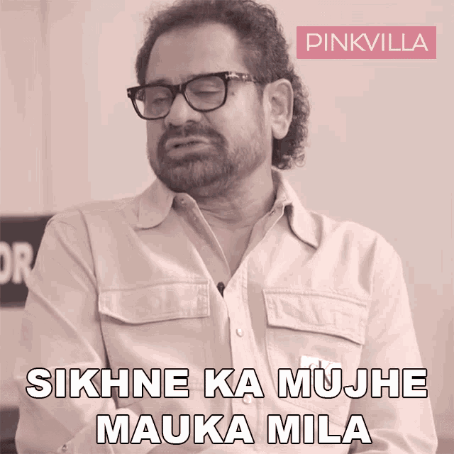 a man wearing glasses and a pinkvilla logo