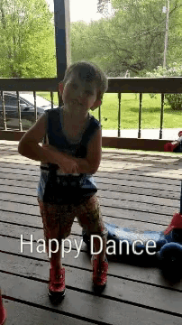 a little boy is dancing on a porch with the words happy dance written below him