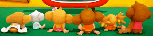 a group of cartoon characters are sitting in front of a tv