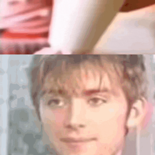 a blurred image of a man 's face with a woman 's face in the background