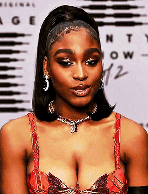 a close up of a woman 's face wearing a necklace and earrings