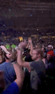 a crowd of people are gathered in a stadium watching a concert .